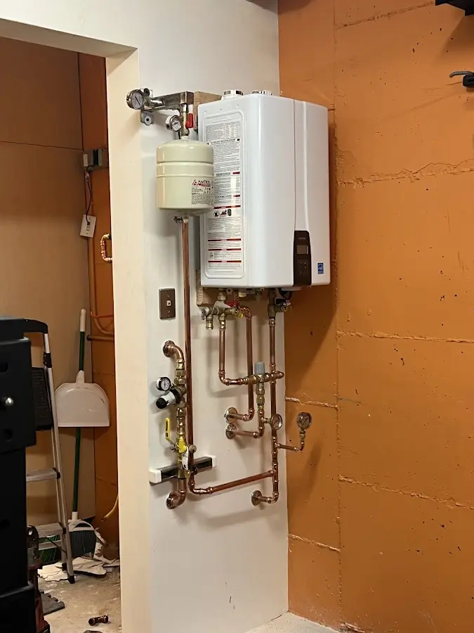Plumbing technician inspecting water heater connections in Boiling Springs